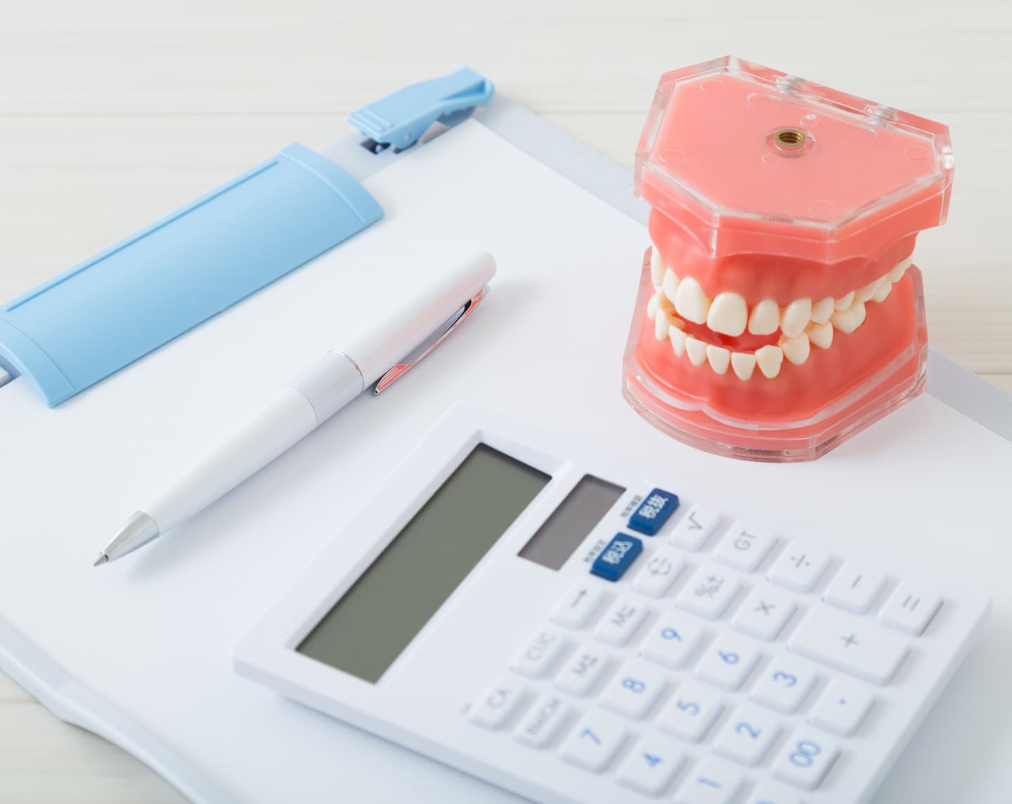 入れ歯・書類・電卓の画像